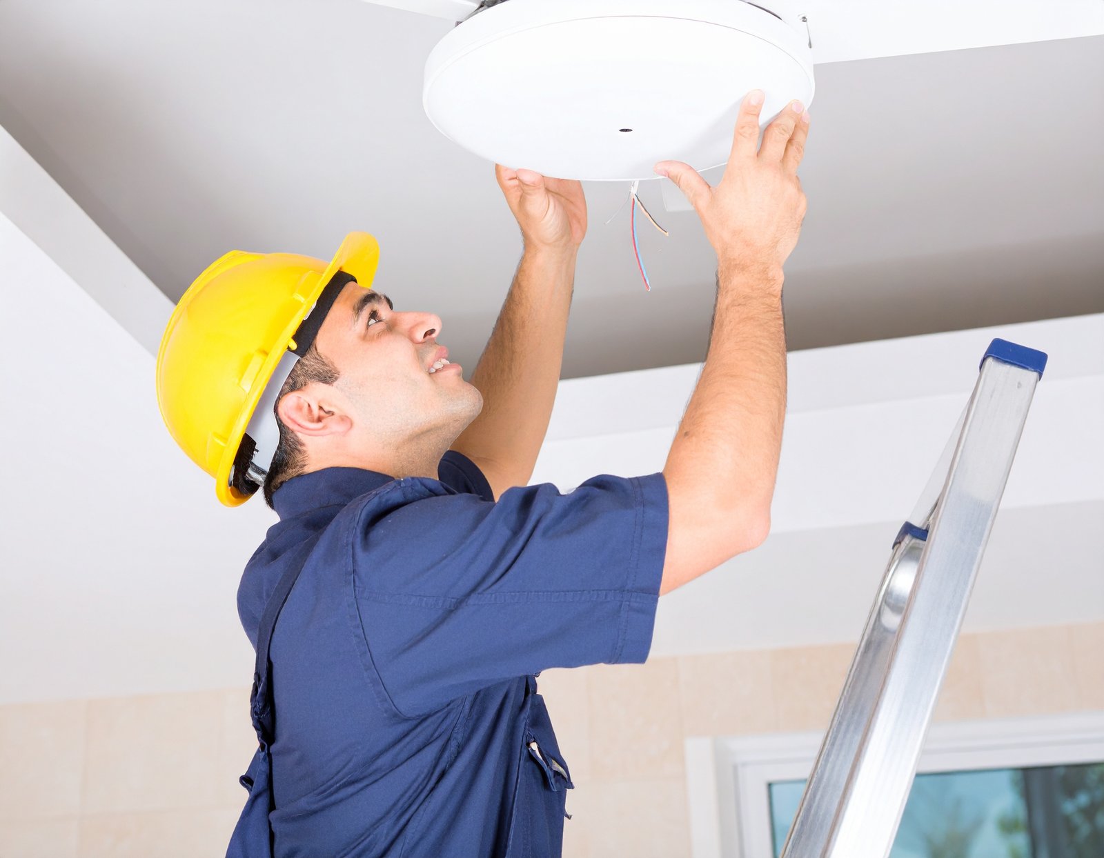 Licensed electrician installing a ceiling fan in Austin TX home
